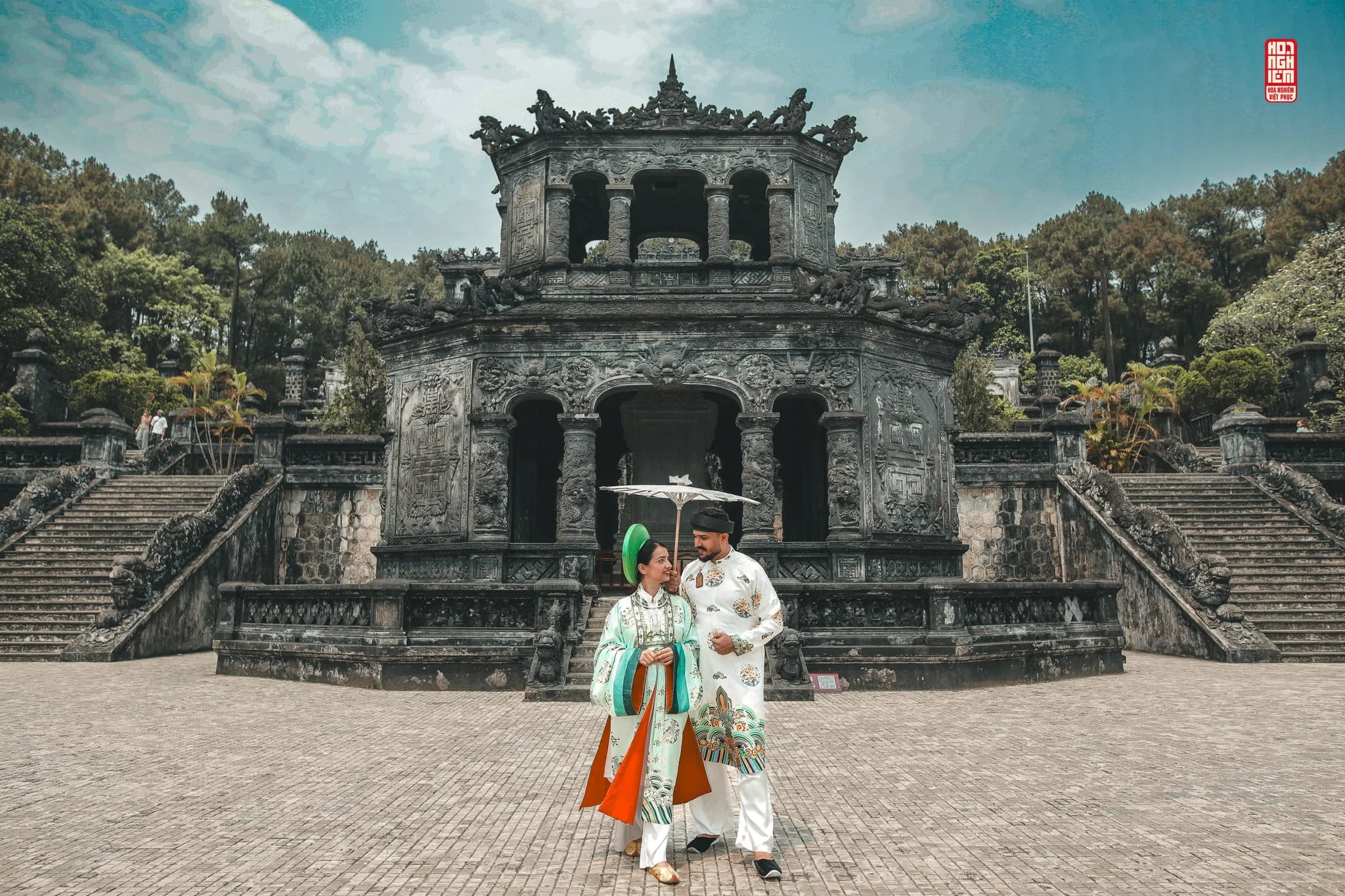 International visitors wearing Vietnamese traditional costumes at Khai Dinh Tomb in Hue, capturing elegant cultural photography surrounded by majestic royal architecture and ancient stone carvings.